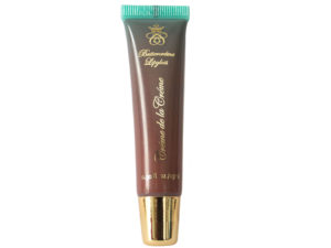 brown nude lip gloss in squeeze tube with gold cap on white background