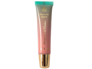 pink lip gloss in squeeze tube with gold cap on white background