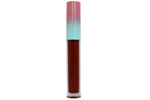 deep red matte liquid lipstick in clear tube with pink and blue cap on white background