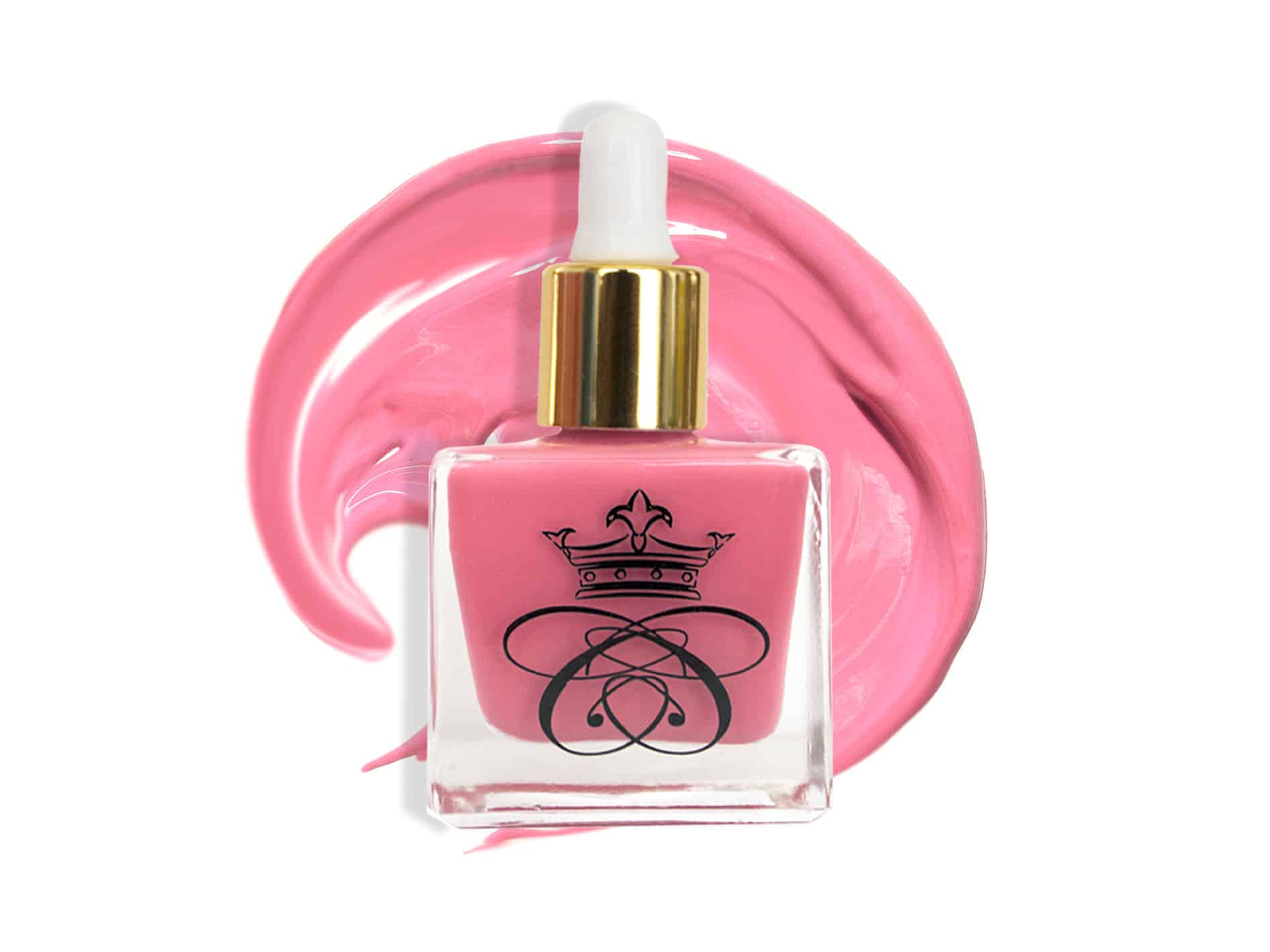 Makeup Must Haves, square glass bottle filled with pink blush with gold and white dropper cap and blush smeared in the background 