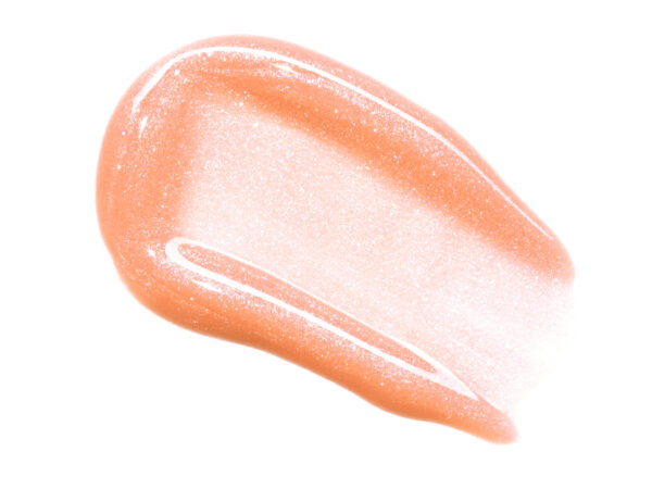 shimmer peach pink lip oil smear on white isolated background