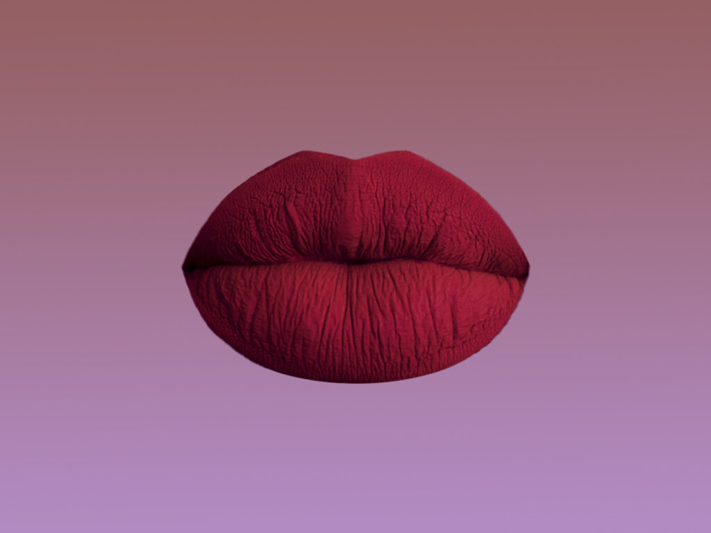 Deep red lipstick on a pair of lips on a brown purple gradient background.