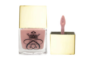 liquid blush in glass bottle with gold cap and wand applicator on white background