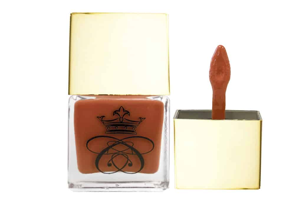 Liquid Blush, square glass bottle with gold cap and wand applicator filled with terracotta liquid blush on white isolated background