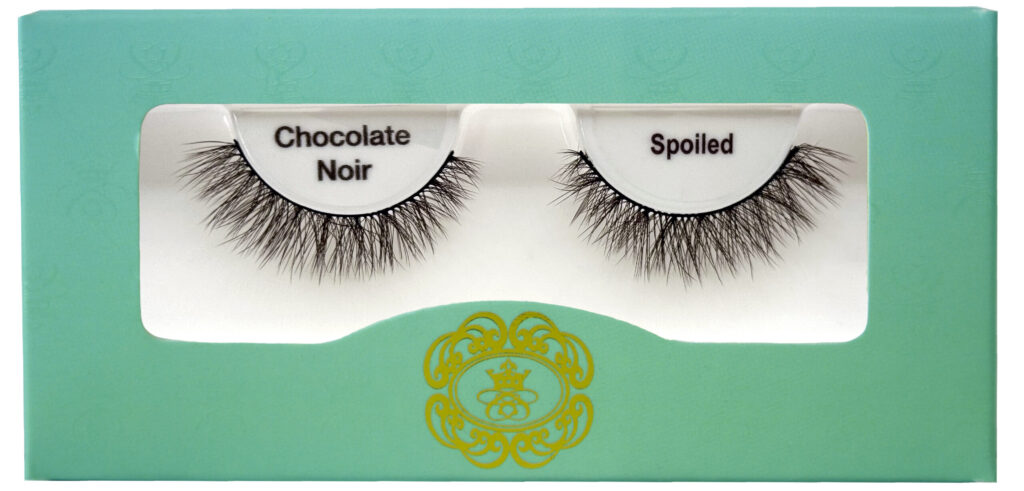 Brown coloured strip eyelashes by cosmetic brand Creme de la Creme beauty on white isolated background