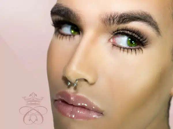 Faux Naturale Strip Eyelash Collection, male model wearing strip eyelashes on light pink background