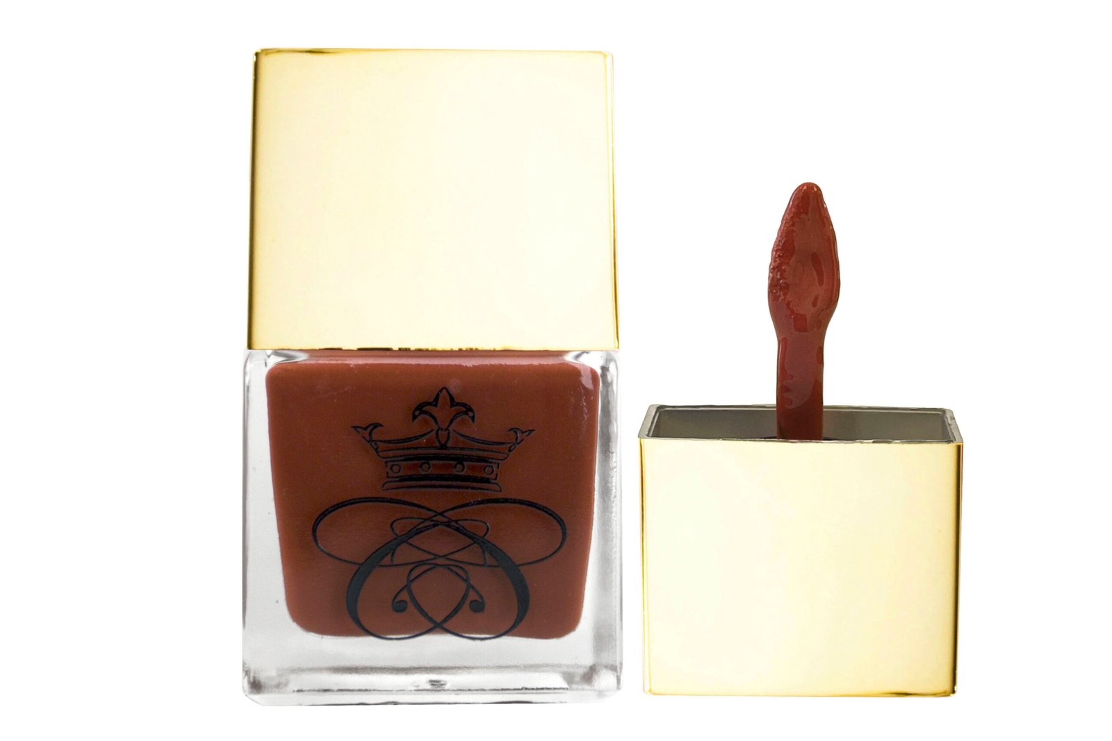 Nitty Gritty Molten Rouge copper-brown, deep-russet red, brick-orange, liquid blush inside square glass bottle with gold cap and wand applicator on white isolated background