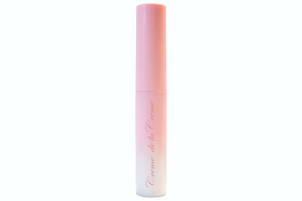 latex free false eyelash glue in gradient pink to white plastic bottle with wand applicator on white isolated background