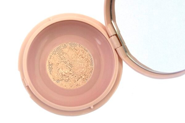 loose makeup powder in translucent plastic jar with pink flap cap lid on white isolated background.