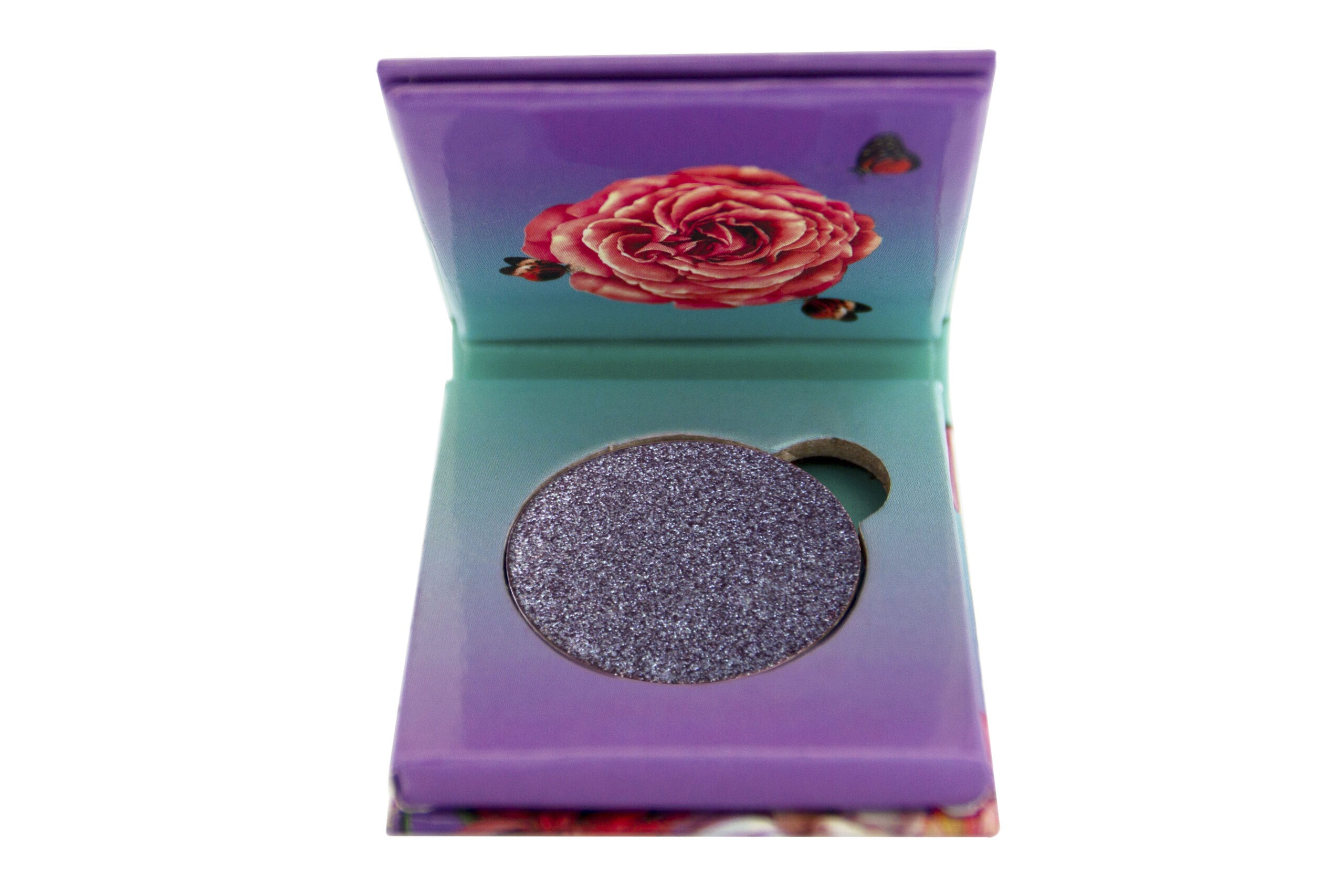 Flamingo Paradise Unearthly Foiled Eyeshadow sitting inside purple and blue 1 pan paper package